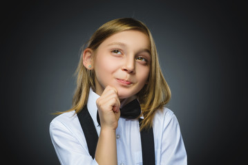Closeup Thoughtful girl with Hand at head isolated on Gray