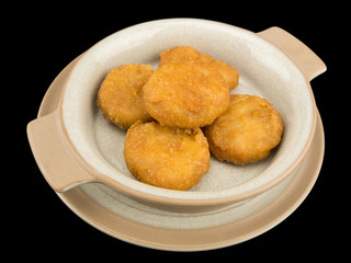 Plate of chicken nuggets isolated on the black background with clipping path