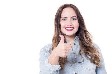Trendy young woman showing thumb up.