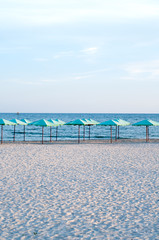 many sun umbrellas in the warm sandy beach