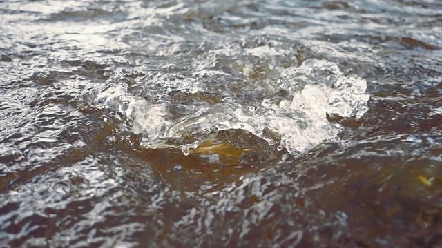 Stormy waves and swirls on the surface of the river. Slow motion, high speed camera, 250fps