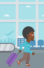 Man walking with suitcase at the airport.