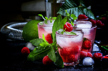 Raspberry mojito alcoholic cocktail with berries, lime, mint and