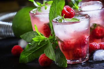Raspberry mojito alcoholic cocktail with berries, lime, mint and