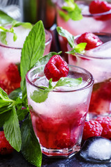 Raspberry mojito alcoholic cocktail with berries, lime, mint and