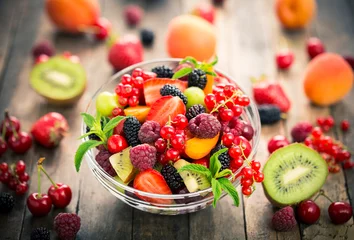 Plexiglas foto achterwand Fresh fruit salad in the bowl  © pilipphoto