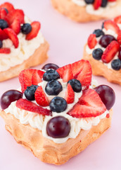 Pavlova dessert with strawberry , cherry and blueberry