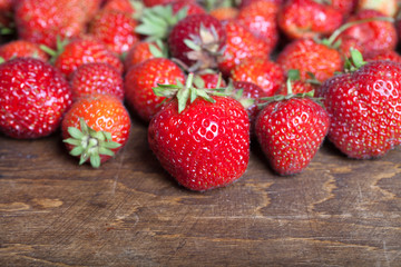 Lots of fresh bright red strawberries. Selective focus. Shallow