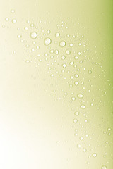 Drops of water on a color background. Green. Toned
