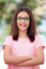 Pretty preteenager girl with glasses outside