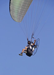 man flying on a parachute
