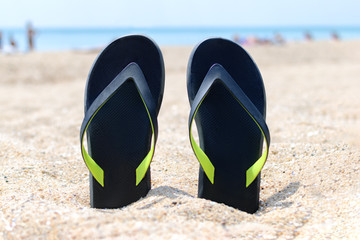 Flip-flops on sand beach.