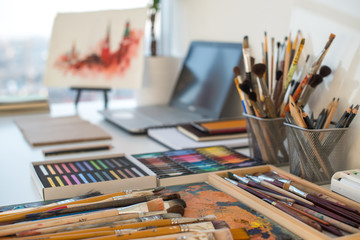 Fototapeta Painter workplace in order side view. Designer desk with drawing equipment. Home studio for artist obraz