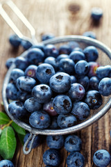 Fresh blueberries from organic cultivation on rustic wooden table, close up