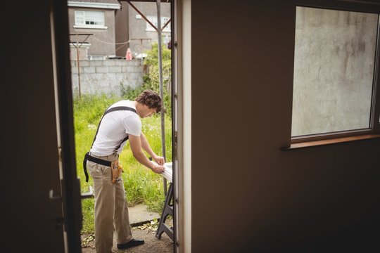 Carpenter measuring a door frame