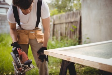 Carpenter working with circular saw