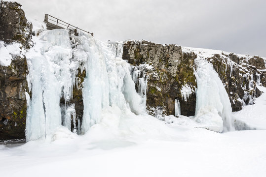 Amazing Kirkjufell frozen waterfall in winter. Iceland