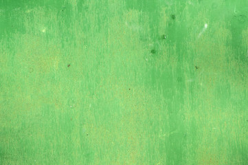 Green painted weathered tin surface closeup as background