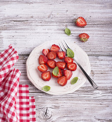 Ripe red strawberries on wooden table