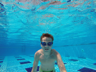 boy diving into a swimming pool © Photobank
