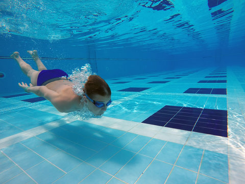 Boy Diving Into A Swimming Pool