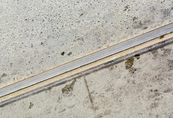 old tram rails in the concrete road gray with dark spots