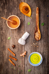 Composition of nature spa ingredients on the dark wooden table.