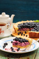 Homemade tart with cottage cheese filling and fresh organic forest blueberries