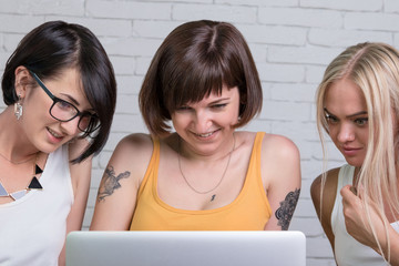 Three women in front of the monitor