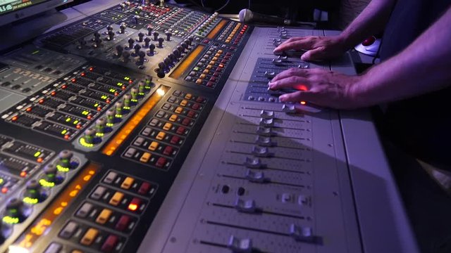 Hands of the Sound Producer Press the Buttons and Move Parts of a Sound Mixer