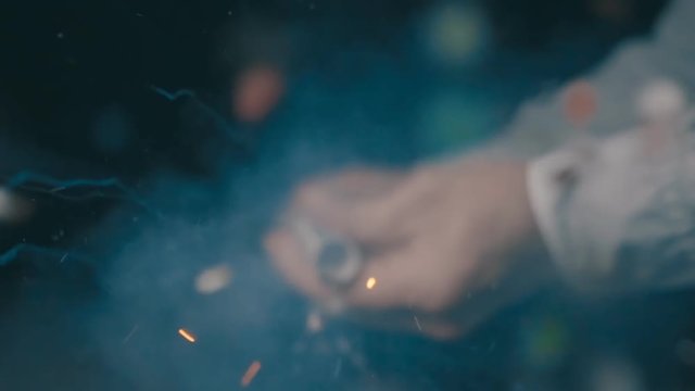 Christmas cracker explodes and confetti flies straight into the camera on black background. Slow motion, high speed camera, 250fps