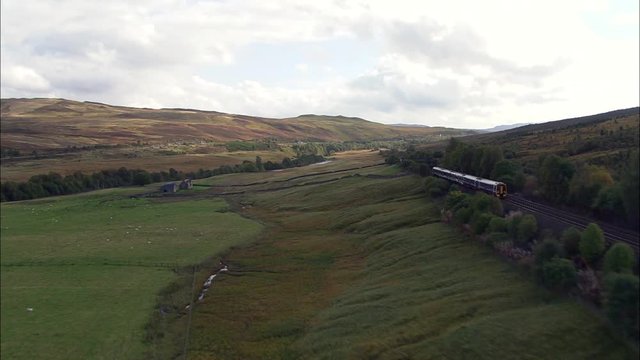 Train Down Glen Garry, Track Adjacent To River, And Surrounding Fields, Forests And Hills