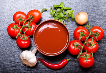 bowl of tomato soup with fresh vegetables