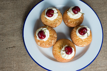Cherry and Almond cupcake on a plate shot overhead