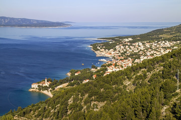 Fototapeta na wymiar Touristic village Bol on Brac island with Dominican Monastery in front, and famous beach Golden cape on background