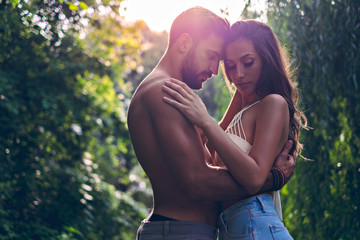 Man cuddle with his girlfriend in the park