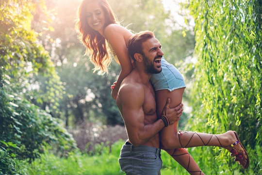 Man lifting his girl up and laughing