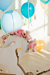 Beautiful wedding decorations with balloons, flowers and a wooden horse