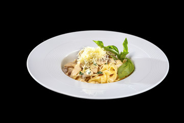 Pasta with mushrooms on black background, isolated.