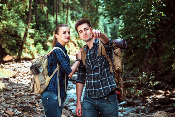 A couple of tourists Hiking backpacks are viewing beautiful landscape mountain river