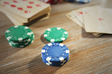 Set to playing poker with cards and chips on wooden background