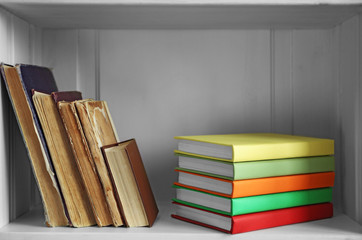 Many books on wooden shelf
