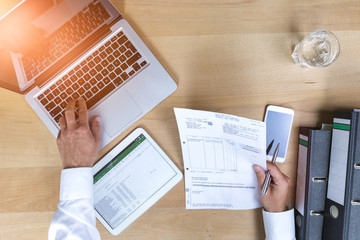 Accounting on a tablet computer and laptop, close-up