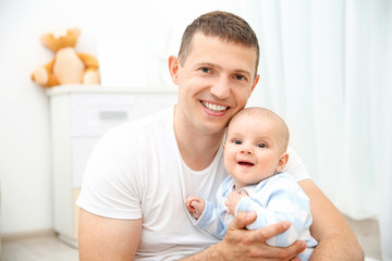 Obraz na płótnie Canvas Happy father holding baby