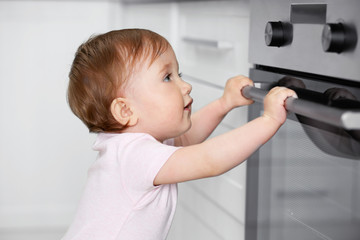 Fototapeta na wymiar Child playing with electric oven