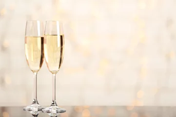  Two champagne glasses on light background © Africa Studio