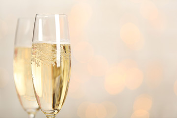 Two champagne glasses on light background