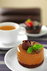 Caramel cake with tea on table