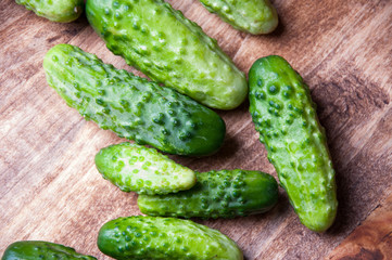The image of fresh cucumber on a wooden table