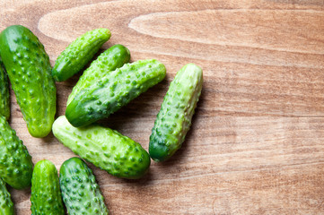 The image of fresh cucumber on a wooden table